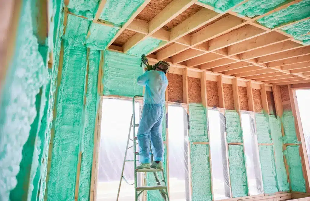 Home Tech Insulation team applying spray foam insulation in Fuquay-Varina to improve energy efficiency and reduce costs.